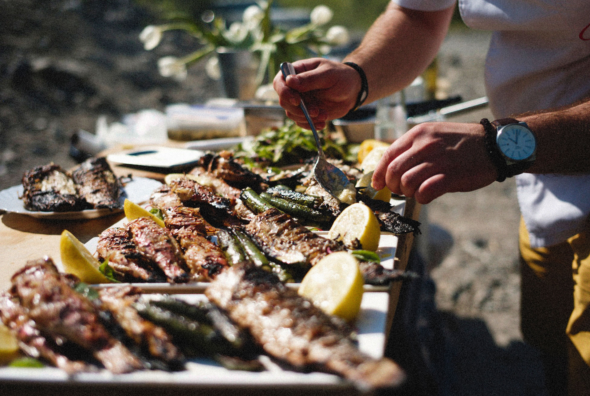 Fresh grilled seafood and lemons served on a wooden board