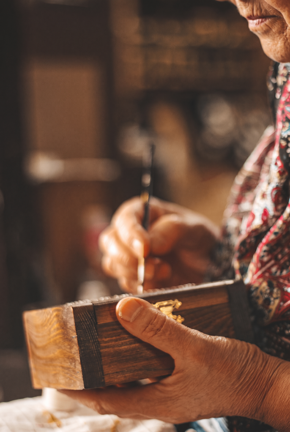 Croatian artisan hand-painting a wooden keepsake box