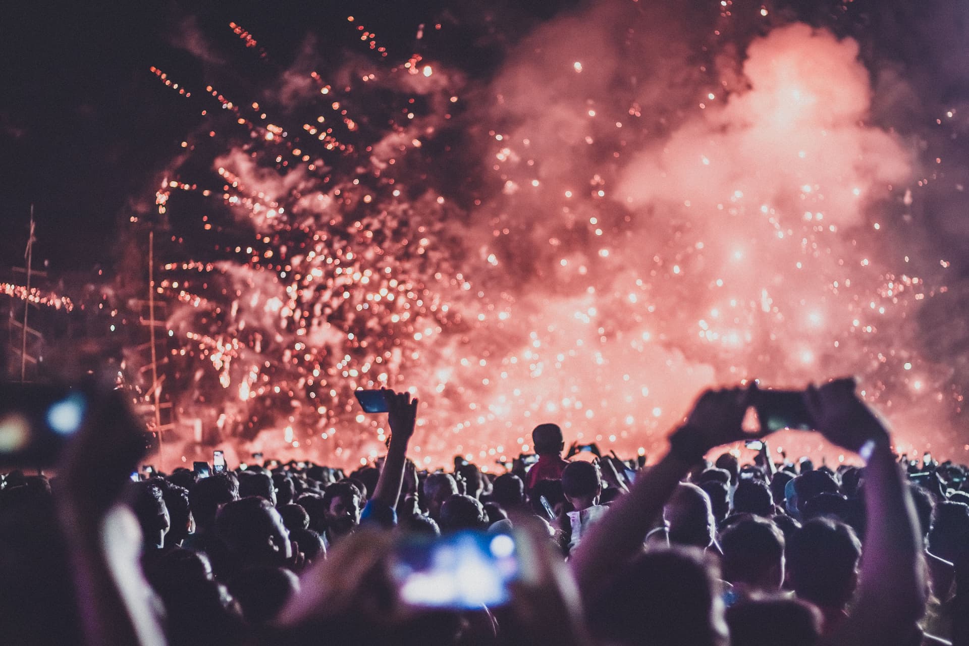 Summer festival crowd under fireworks and stage lights